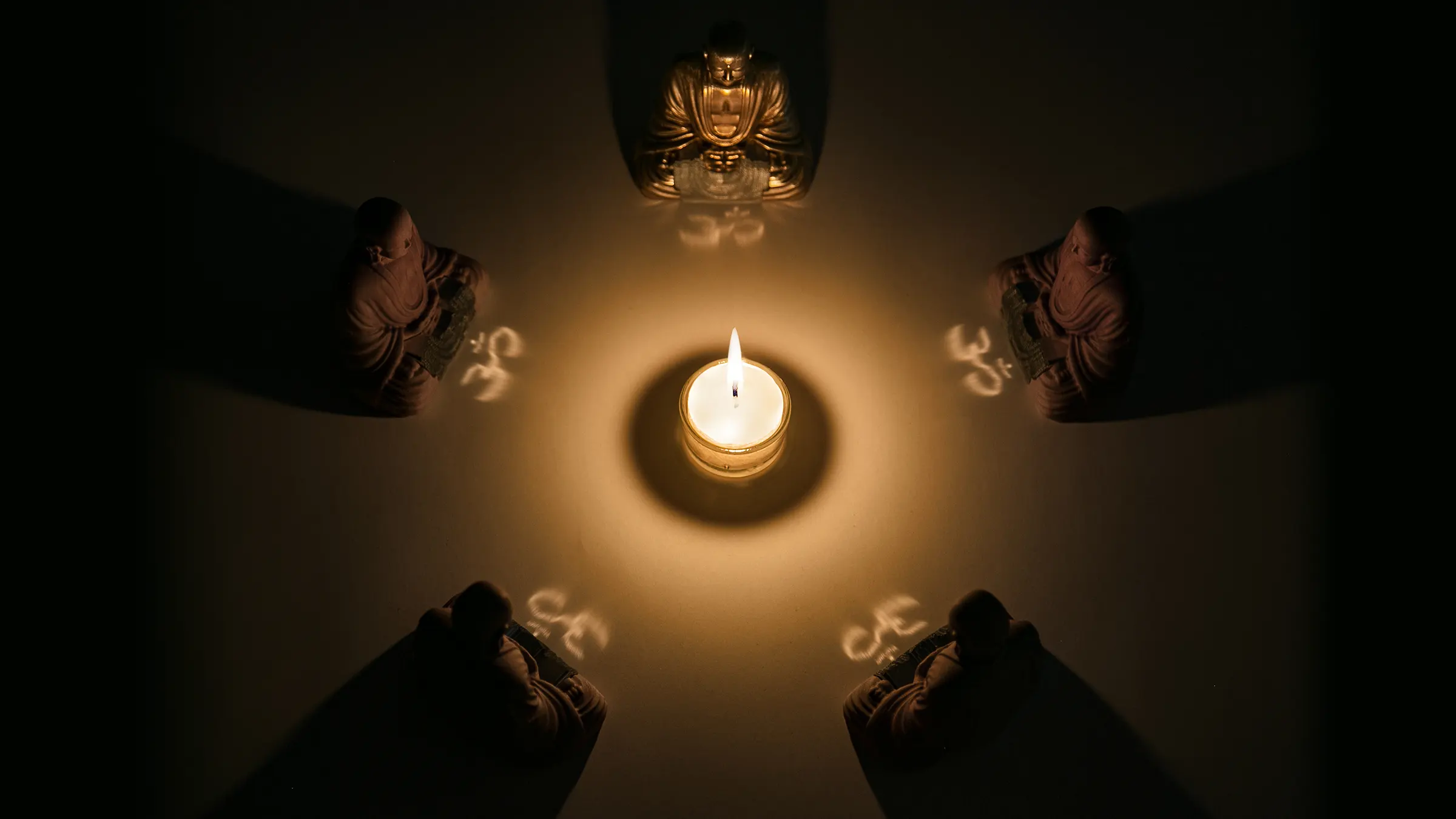 Five figures positioned in a circle around the candle.
